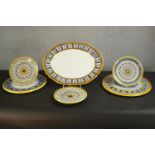 A collection of Italian hand painted ceramic majolica platters and plates, including a large oval