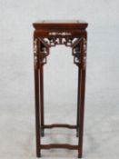 A Chinese carved and pierced hardwood urn stand inlaid with mother of pearl bird and floral