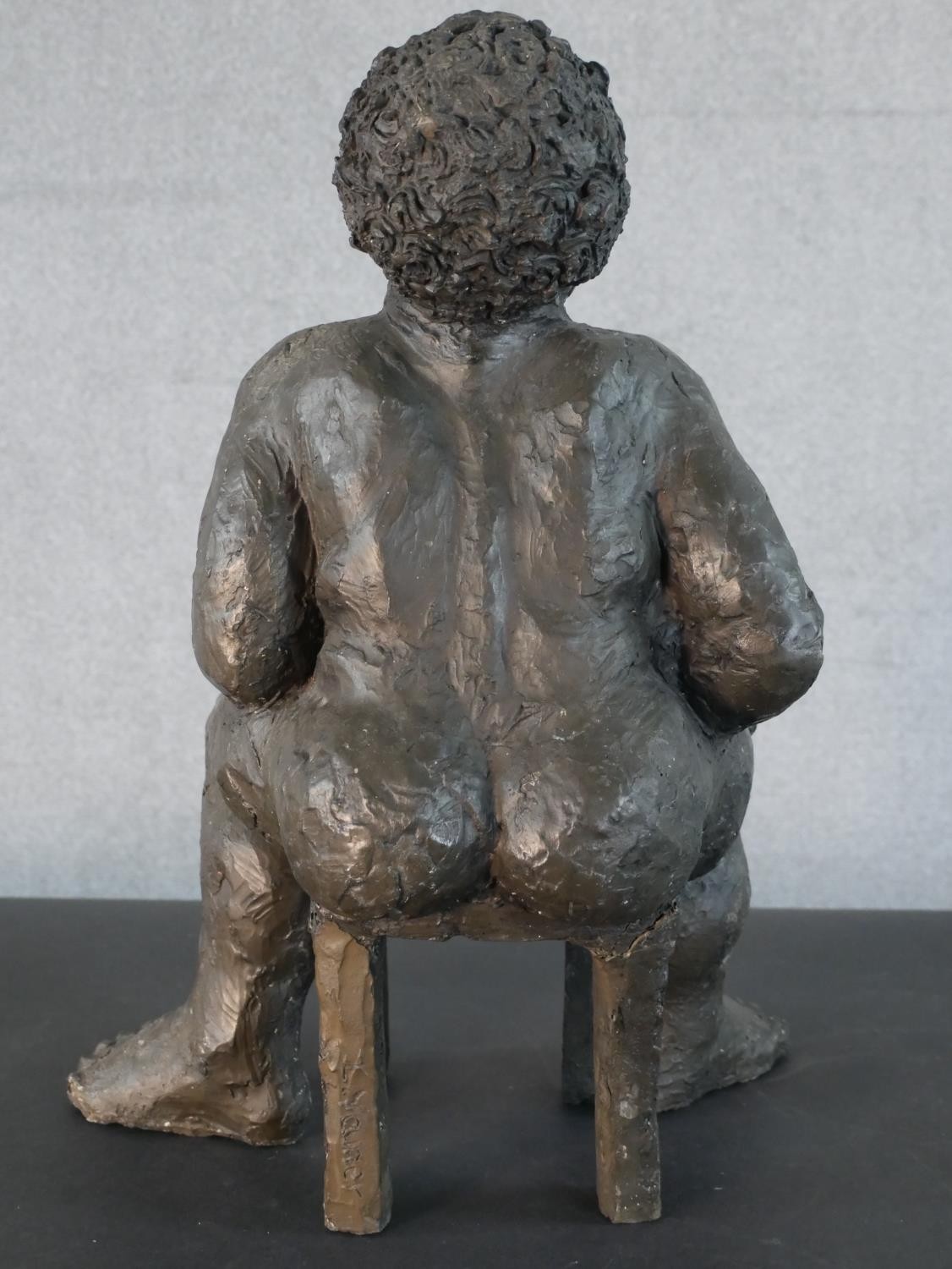 A bronzed moulded figure of a nude woman on a seat laughing, indistinctly signed. H.49 W.36 D.20cm - Image 3 of 6