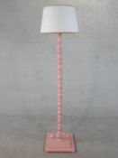 A carved and pink painted 'Elodie' standard lamp. H.180cm