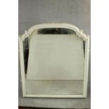 An arched overmantel mirror with a white painted moulded frame. H.137 W.125cm.