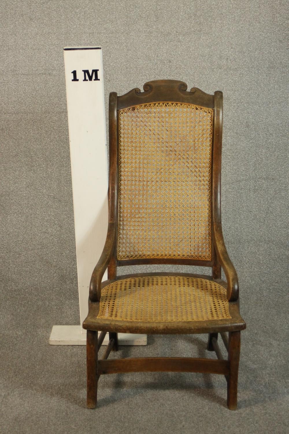 A circa 1900 hardwood nursing chair, with a caned seat and back, the legs joined by stretchers. - Image 2 of 7