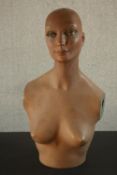 A mid 20th century painted fibreglass female mannequin bust H.61 W.29 D.25cm.