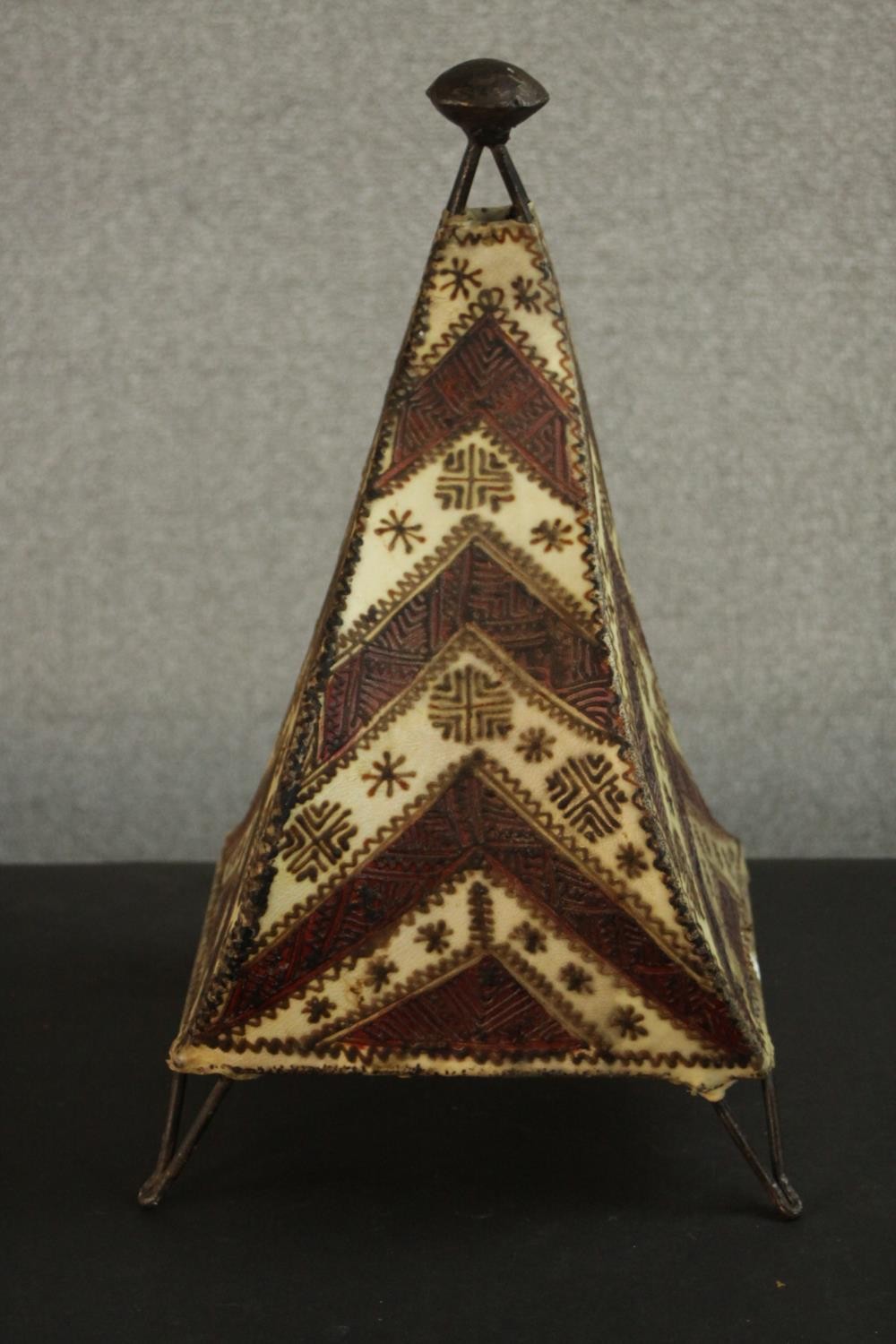 A vintage Moroccan leather and henna design pyramidal table lamp. H.46 W.25 D.27cm.