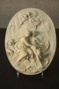 A relief Classical style moulded plaque depicting a pair of seated gods with flying putti, one