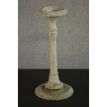 A Victorian cast iron pricket candlestick, white painted and distressed. H.45 Dia.20cm.