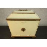A 19th century sarcophagus form box, painted an ivory hue and parcel gilt, with a handle to the