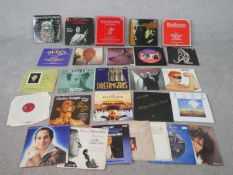 A collection of approximately twent nine vintage vinyl records, including Rod Stewart, Queen and