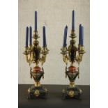 A pair of Continental cast, painted and gilded candelabra, each with four branches, holding five