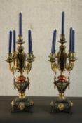 A pair of Continental cast, painted and gilded candelabra, each with four branches, holding five