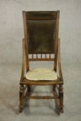 A late 19th century fruitwood rocking chair, the back upholstered in brown velour with studded
