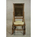 A late 19th century fruitwood rocking chair, the back upholstered in brown velour with studded