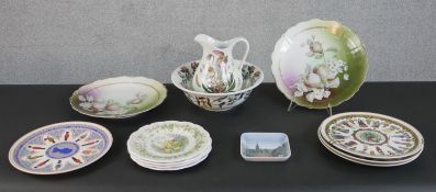 A collection of wall plates and other ceramics, including a Botanical Garden Portmeirion jug and