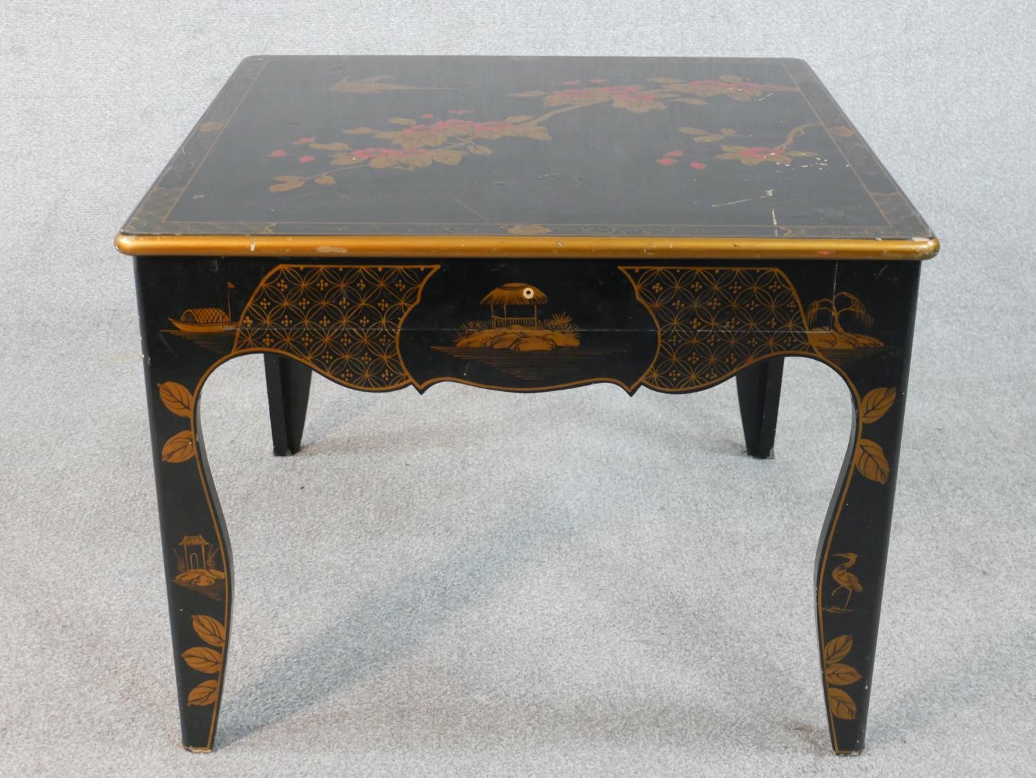 A black lacquered Chinese low table with hand gilded bird and blossom decoration. W.66 H.52 D.66cm