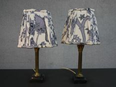 A pair of 20th century brass Corinthian column table lamps on square marble bases, with contemporary