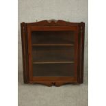A 19th century walnut corner cabinet, the glazed door enclosing shelves. H.77 W.70 D.34cm