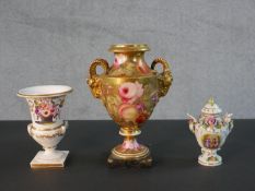 Three 19th century hand painted porcelain urns, one with gilded rams head handles and rose design (