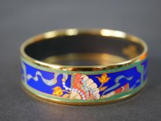 Hermès, a boxed gold plated and enamel Oriental folding fan design bangle with blue ground, makers