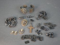 A collection of carved jet, black glass and moulded plastic jewellery, beads and buttons including