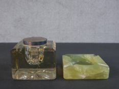 A silver lidded Mappin and Webb large glass inkwell with star cut base along with a carved alabaster