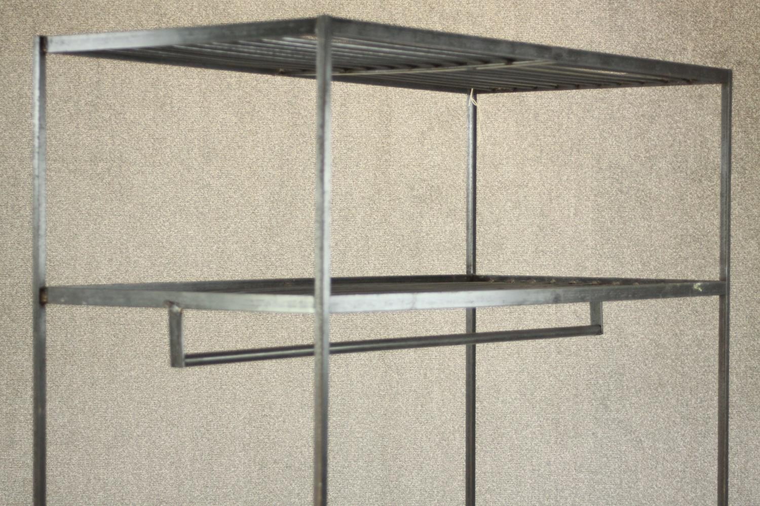 A wrought iron industrial rack, with a rail suspended from below a shelf, over another shelf to - Image 5 of 6