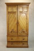 A Victorian Aesthetic movement pitch pine wardrobe, the two ecclesiastical style doors with