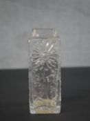 A Whitefriars style relief flower design clear glass vase. H.16 W.6.5 D.6cm