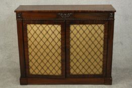 A Regency rosewood chiffonier, the rectangular top over two brass grille doors with yellow pleated