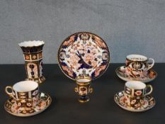 A collection of nine hand painted and gilded Imari and Japan design Crown Derby pieces, including