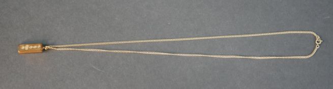 A 9c carat gold trace chain and ingot pendant. Hallmarked: RP, 375, Sheffield, 1978. The chain