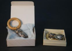 Two 20th century Danish silver rattles, one with an owl and one with an angel.