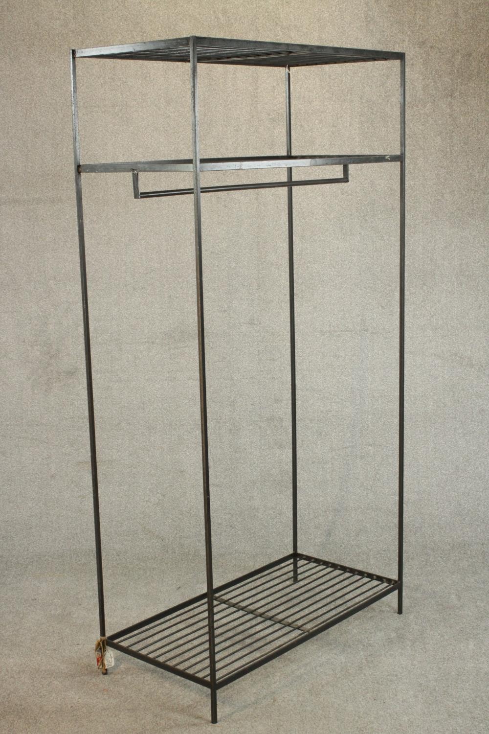 A wrought iron industrial rack, with a rail suspended from below a shelf, over another shelf to - Image 4 of 6