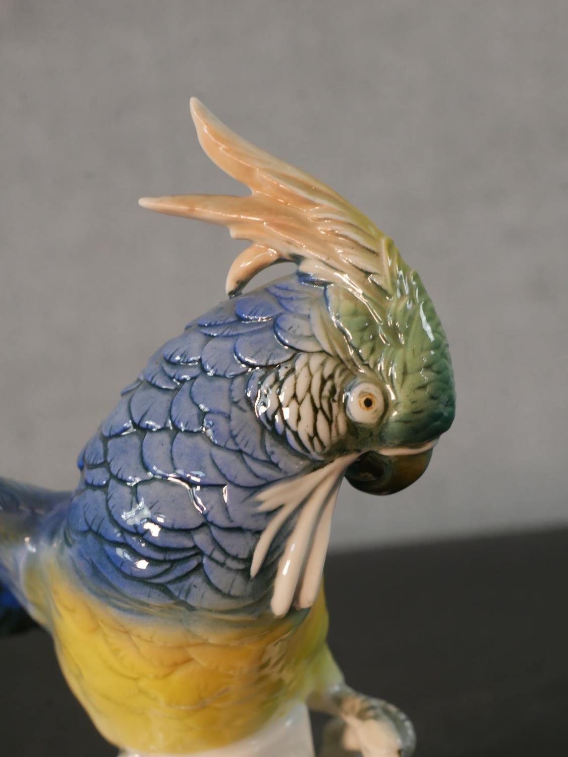 A Karl Ens porcelain blue and yellow parrot perched on a leafy branch, blue printed factory mark - Image 4 of 5