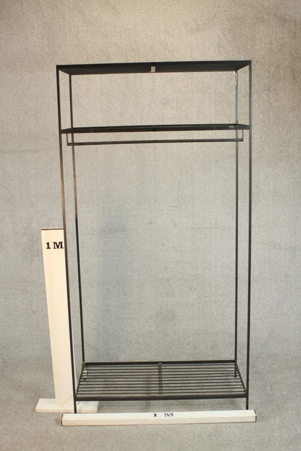 A wrought iron industrial rack, with a rail suspended from below a shelf, over another shelf to - Image 2 of 6