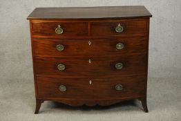 A George III mahogany bow front chest, early 19th century, with two short over three long