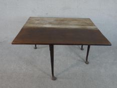 An 18th century mahogany drop leaf dining table, with a single drop leaf, on tapering legs
