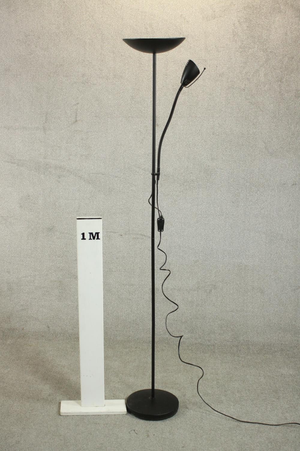 A contemporary ebonised uplighter and reading lamp, the reading lamp on an adjustable arm, on a - Image 2 of 7