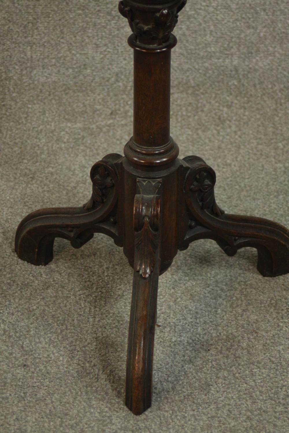 A Victorian ecclesiastical mahogany occasional table, with a circular top supported by carved - Image 3 of 6