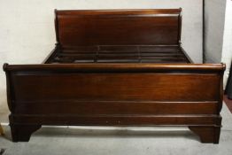 A contemporary French style mahogany double sleigh bed with slats. H.96 W.127 D.185cm.