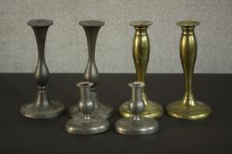 Three pairs of candle holders, two pairs of early 20th century pewter candlesticks and a pair of