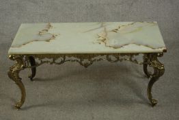A Rococo style brass coffee table, the rectangular onyx top with a moulded edge, the base with a