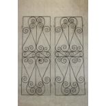 A pair of black painted wrought iron gates, decorated with spiral designs. H.177 W.64cm. (each)
