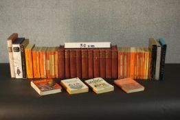 A collection of books, including a set of British encyclopedias, various Penguin books and folio