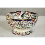 An Amhurst Japan Ironstone ceramic bowl with stylised floral design, stamp to base. H.14 Dia.24cm.