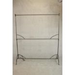 A two tier wrought iron clothes or drying rack. on scrolling legs. (One leg bent) H.176 W.152 D.