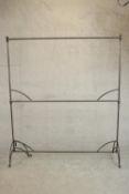 A two tier wrought iron clothes or drying rack. on scrolling legs. (One leg bent) H.176 W.152 D.