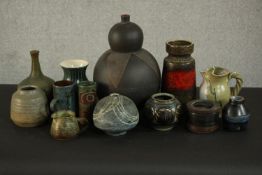 A collection of thirteen pieces of mid-century art pottery, including vases, coffee cups and jugs,