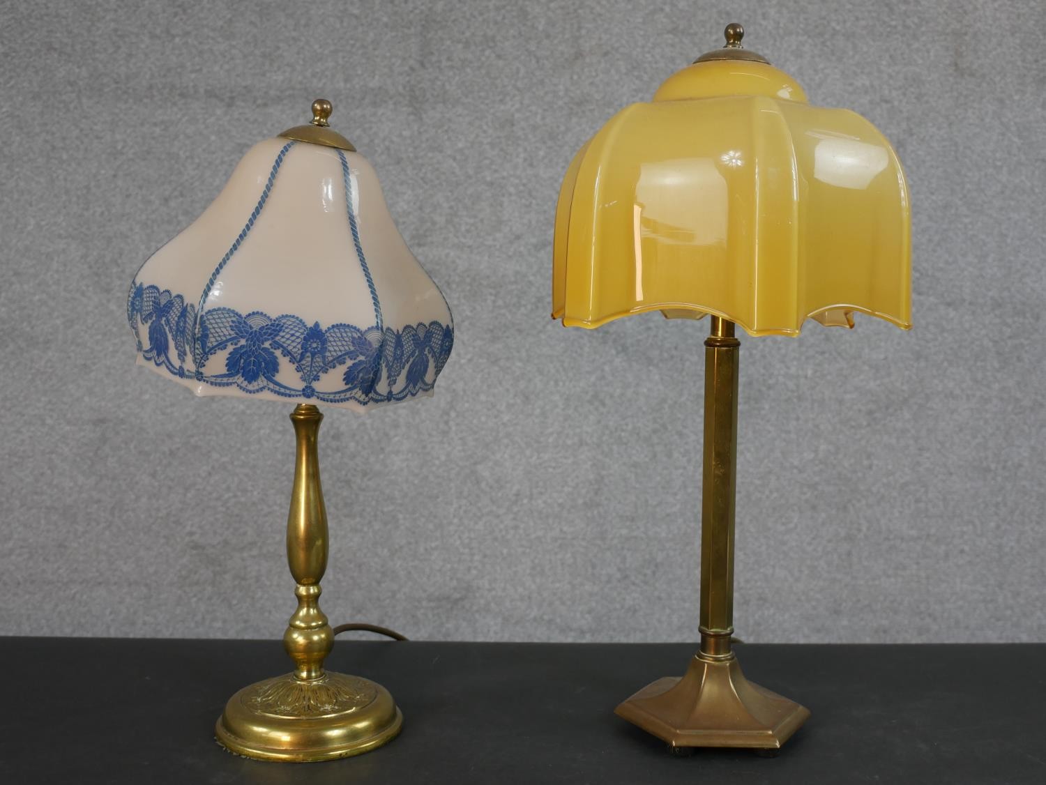 Two mid 20th century brass table lamps, one with a yellow glass shade, the other with a blue and