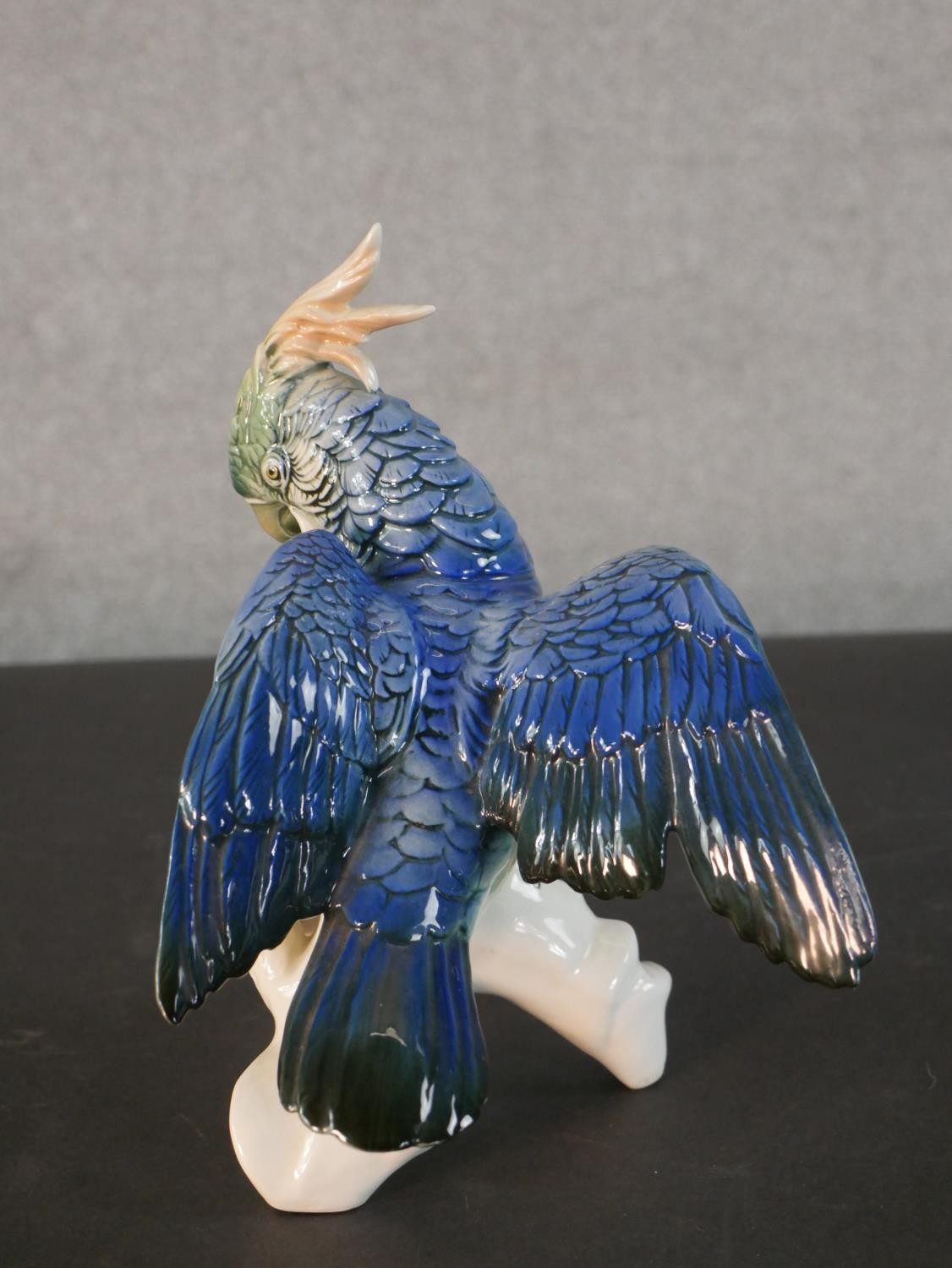 A Karl Ens porcelain blue and yellow parrot perched on a leafy branch, blue printed factory mark - Image 2 of 5