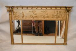 A Regency gilt overmantel mirror, the cornice adorned with balls, over a Classical figural panel,